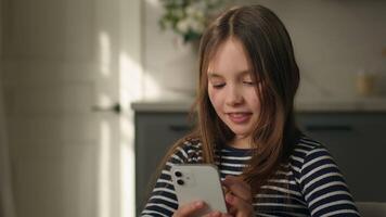 Little Caucasian girl holding mobile phone smartphone telephone internet communicate wifi texting sms chatting e-learning child preteen kid daughter typing networking messaging virtual web tech gadget video