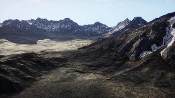 An aerial view of a mountain range with snow on the mountains video