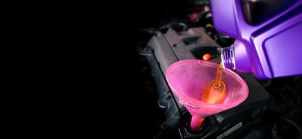 Engine oil is poured into the funnel for lubricating the engine , Horizontal banner with copy space for text , Car maintenance concept photo