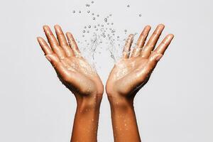 A pair of sweaty hands with water droplets splashing around them. photo