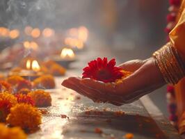 A hand holding marigold flowers during a ritual in Pitru Paksha. photo