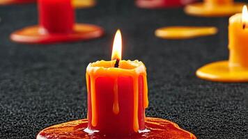 A red candle with melting wax sitting in a pool of melted wax, evocative of tranquility and reflection, associated with Christmas and Diwali celebrations video