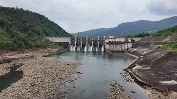 A scenic view of a hydroelectric dam surrounded by lush green mountains, ideal for environmental conservation and Earth Day themes video