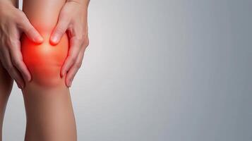 Close-up of hands holding a knee with pain. Emphasis on discomfort and joint health, illustrating injury or strain. photo