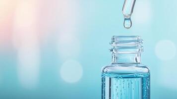 A close-up of a glass bottle with a dropper, showcasing a water drop ready to fall, on a soft blue background. photo