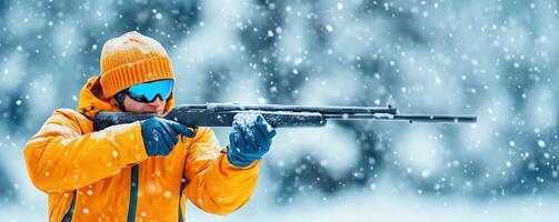 A person in a bright orange jacket aiming a rifle in a snowy landscape, showcasing winter sports and wildlife hunting. photo