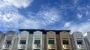 Old town buildings under a vibrant blue sky with clouds. Perfect for architecture and urban photography themes photo