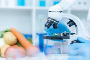 Scientist check chemical food residues in laboratory. Control experts inspect quality of fruits, vegetables. lab, hazards, ROHs, find prohibited substances, contaminate, Microscope, Microbiologist photo
