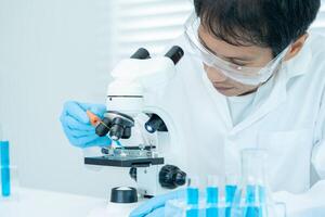 Scientist analyze biochemical samples in advanced scientific laboratory. Medical professional use microscope look microbiological developmental of viral. Biotechnology research in science lab. photo