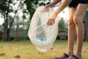 Save earth. Volunteer pick up trash garbage at the park and plastic bottles are difficult decompose prevent harm. Earth, Environment, Greening planet, reduce global warming, Save world ,pollution photo