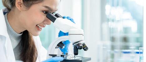 Scientist analyze biochemical samples in advanced scientific laboratory. Medical professional use microscope look microbiological developmental of viral. Biotechnology research in science lab. photo