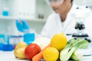 Scientist check chemical food residues in laboratory. Control experts inspect quality of vegetables vegetables. lab, hazards, find prohibited substances, contaminate, Microscope, Microbiologist photo
