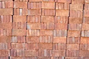 Pile of red bricks texture background photo