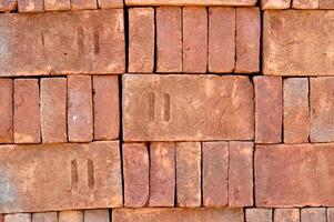 Pile of red bricks texture background photo