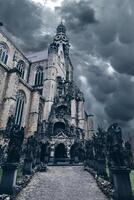 Ominous dark cathedral with a dramatic sky on the background photo