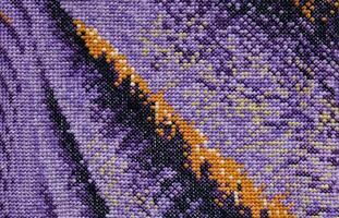Purple, violet and brown close-up cross stitch background. Abstract Embroidered handmade Pattern. Needlework and DIY concept. Top view, macro, flat lay, mockup. photo