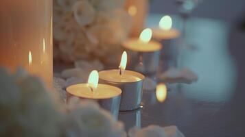 Numerous tiny candles illuminate a table, setting a romantic mood for a wedding photo