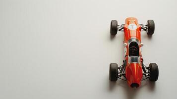 Vintage orange toy racing car on white background, invoking nostalgia and the excitement of speed photo