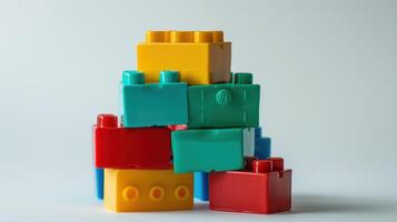 Assortment of vibrant toy bricks delicately arranged on a white surface photo