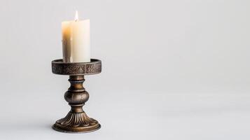 Elegant candlestick holds a burning white candle, creating a cozy and welcoming ambiance photo
