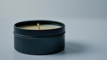 Serene black candle in a tin jar on a white background, promoting relaxation and mindfulness photo