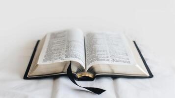 Open holy bible on a white cloth, perfect for religious projects, conveys peace and contemplation photo