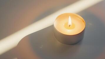 White burning scented candle is standing on a table and creating cozy atmosphere at home photo