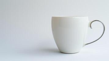 White porcelain coffee mug with silver handle on a white surface photo