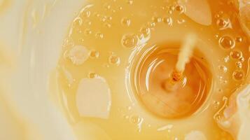 Captivating close-up of golden honey flowing gently, forming bubbles against a blurred background. Perfect for food, health, and organic concepts photo