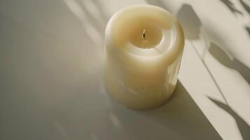 Serene and minimalist aesthetic is created by a white pillar candle casting a shadow photo