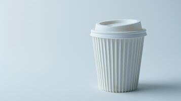 White paper coffee cup with plastic lid standing on blue background with copy space photo
