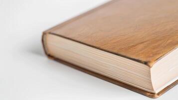 Old leather-bound book with yellowed pages on a white table, exuding wisdom and charm photo