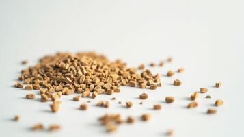 Mound of freeze-dried coffee crystals rests on a clean white surface. photo