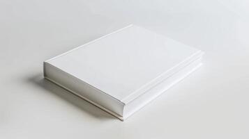Blank white book with a thick spine is set against a white backdrop photo