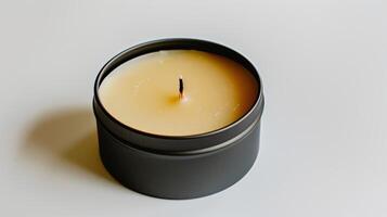 Warm beeswax candle in a black tin, emitting a cozy glow for relaxation photo
