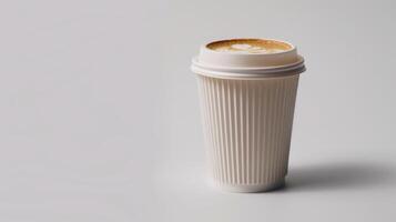 White coffee cup with a plastic lid is placed on a white surface photo