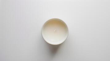 White scented candle illuminates a serene white setting, evoking a calming and peaceful ambiance photo