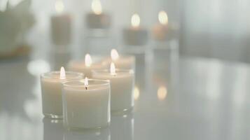 Cluster of white burning candles setting a romantic mood on a mirrored surface photo