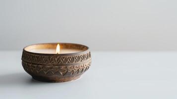 Burning scented candle in a rustic ceramic holder is spreading a pleasant aroma photo