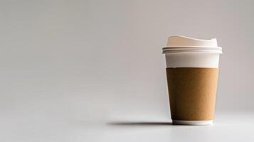 Empty coffee cup with a cardboard holder is placed on a blank white surface with space for text photo