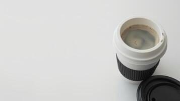 Open disposable coffee cup is displayed against a white backdrop, revealing the contents inside photo