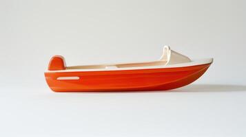 Small orange and white toy speedboat rests peacefully on a plain white background photo