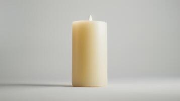 Solitary white candle illuminates a white backdrop, creating a simple and minimalist look photo