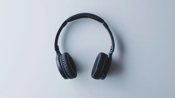 Black wireless headphones lying on a white background, a concept image about music photo
