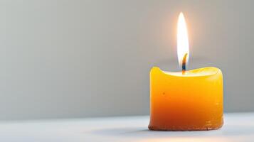 Solitary yellow candle flickers with a radiant flame, creating a cozy and welcoming ambiance photo