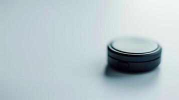 Tiny black gps tracker rests on a white background, poised to offer location data photo