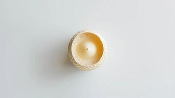 Round decorative scented candle with textured surface on a white backdrop photo