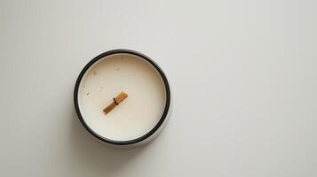 Serene scene with a white scented candle on a wooden wick photo