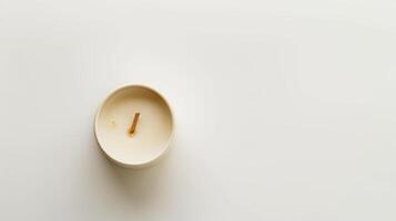 Soy candle with wooden wick burning on white backdrop photo