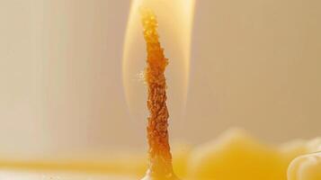 Up-close look at a flickering candle flame, casting a cozy and welcoming light on its surroundings photo